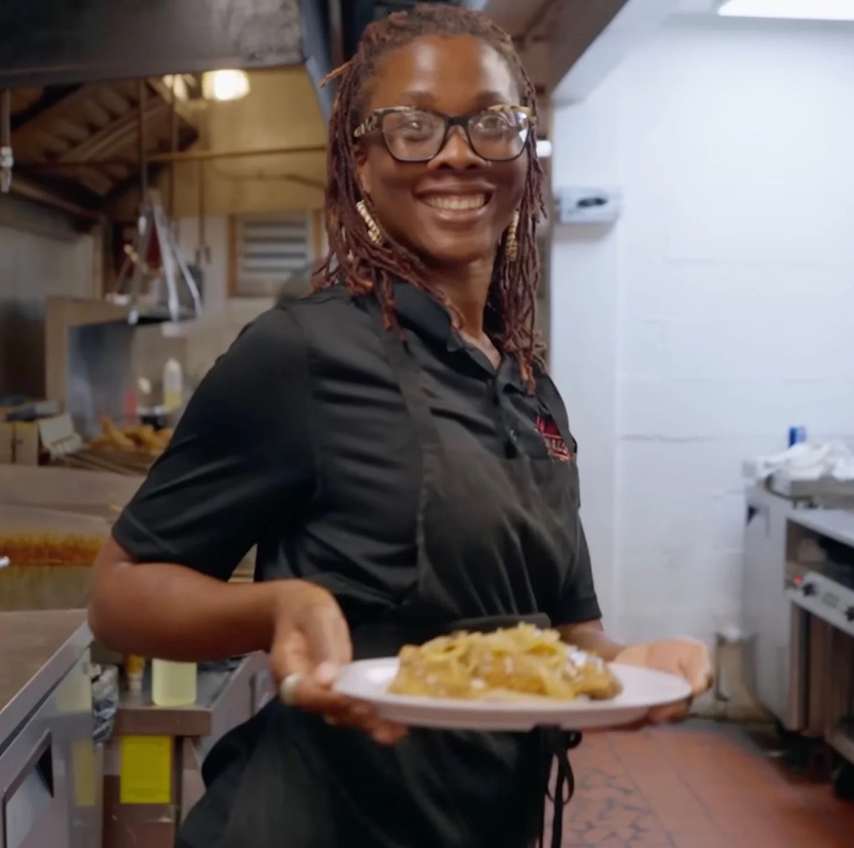 A Hannibal’s Kitchen team member holding a plate of food