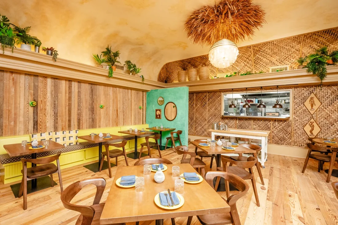 Kultura’s dining room with wooden tables and colorful decor