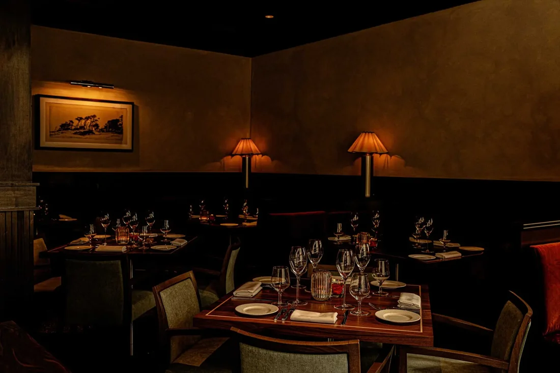 The softly lit dining room at Bellerose Hotel Bar